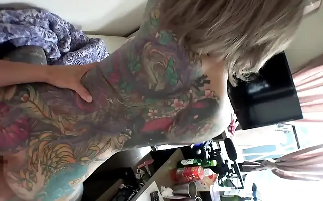 Two tattooed lovers explore deep passion with hungry kisses and intimate touches