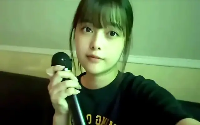 Straddles the karaoke mic in innocent ecstasy