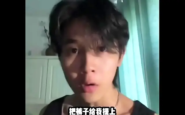 Sunlight streams through a bedroom window as a sexy Chinese man poses with confidence