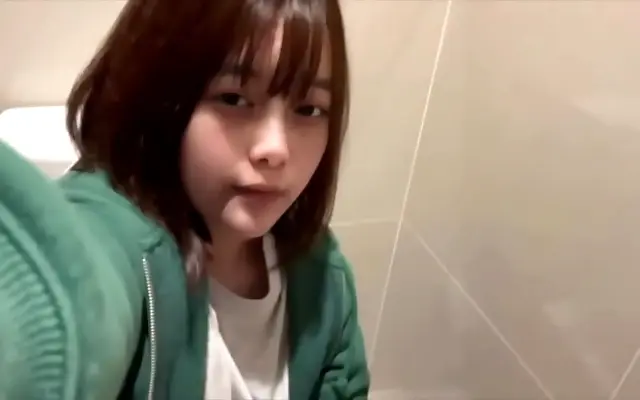 Blue lit mall bathroom where she slips away for secret pleasures